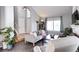 Cozy living room featuring a fireplace, tiled floors, and large windows at 3889 S Fraser St, Aurora, CO 80014
