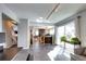 Open concept living room featuring tile floors, a view into the kitchen and dining area, and large sliding glass doors at 3889 S Fraser St, Aurora, CO 80014