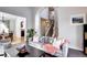 Open-concept living area flows to dining and stairway, featuring modern furnishings and decor at 3889 S Fraser St, Aurora, CO 80014