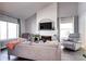 Bright living room features a fireplace with TV mount and large windows for natural light at 3889 S Fraser St, Aurora, CO 80014
