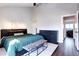 Well-lit main bedroom featuring hardwood floors, modern furniture, and neutral paint at 3889 S Fraser St, Aurora, CO 80014
