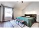 Cozy main bedroom featuring a large window, modern furniture, and hardwood floors at 3889 S Fraser St, Aurora, CO 80014