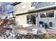 Spacious patio with outdoor seating, a grill, and a sliding glass door leading indoors, perfect for relaxation and entertainment at 3889 S Fraser St, Aurora, CO 80014