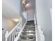 Carpeted staircase with bright natural light and access to the upper floor at 3889 S Fraser St, Aurora, CO 80014