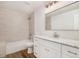 Modern bathroom with marble vanity, subway tile, and bright lighting at 2685 S Dayton Way # 234, Denver, CO 80231