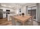 Bright dining room featuring wood table and chairs with access to modern kitchen at 2685 S Dayton Way # 234, Denver, CO 80231