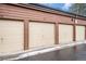 Row of private garages with neutral doors and brown trim and house number on the top at 2685 S Dayton Way # 234, Denver, CO 80231