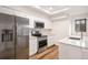 Well-lit modern kitchen with stainless steel appliances and white cabinets at 2685 S Dayton Way # 234, Denver, CO 80231
