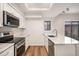Modern kitchen features stainless steel appliances, granite countertops, and wood floors at 2685 S Dayton Way # 234, Denver, CO 80231