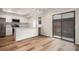Contemporary kitchen featuring stainless steel appliances, white cabinets, and sliding door to the patio at 2685 S Dayton Way # 234, Denver, CO 80231