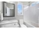 Full bathroom with updated vanity and mirror, full-sized bath tub, and natural light at 9342 Bear River St, Littleton, CO 80125