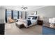 Bright bedroom with a ceiling fan, ensuite bathroom and multiple windows to let in natural light at 9342 Bear River St, Littleton, CO 80125