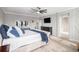 Large main bedroom boasts geometrically designed wall accents and an ensuite bath and walk-in closet at 9342 Bear River St, Littleton, CO 80125