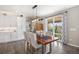 Bright dining room features modern lighting, a rustic table, and sliding glass doors to the backyard at 9342 Bear River St, Littleton, CO 80125