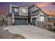 Modern two-story home features stone accents, a spacious driveway, and an attached two-car garage at 9342 Bear River St, Littleton, CO 80125