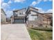 Beautiful two-story home showcases stone accents, varied exterior design, and a wide driveway at 9342 Bear River St, Littleton, CO 80125