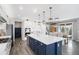Spacious kitchen featuring a large island with quartz countertops and stylish pendant lighting at 9342 Bear River St, Littleton, CO 80125