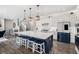 Bright kitchen features white cabinets, stainless steel appliances, and a spacious center island with seating at 9342 Bear River St, Littleton, CO 80125