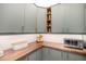 Kitchen with green cabinets, wood countertop and subway tile backsplash at 9342 Bear River St, Littleton, CO 80125