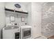 Laundry room with side-by-side washer and dryer, shelving and wallpaper at 9342 Bear River St, Littleton, CO 80125