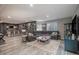 Open living area featuring stylish furnishings, unique accent wall, wet bar and wood-look floors at 9342 Bear River St, Littleton, CO 80125