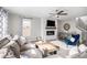 Comfortable living room with a modern fireplace, large windows, and a stylish ceiling fan at 9342 Bear River St, Littleton, CO 80125