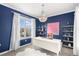 Elegant office space with blue walls, white desk and chandelier, plus neighborhood views at 9342 Bear River St, Littleton, CO 80125