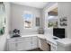 Bright office space with white built-ins and desk, plus natural light from windows at 9342 Bear River St, Littleton, CO 80125