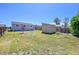 View of a spacious backyard with grass, a small storage shed, and a wooden fence at 7831 Hollywood St, Commerce City, CO 80022