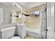 Clean bathroom featuring a bathtub, shower, vanity, and neutral tilework at 7831 Hollywood St, Commerce City, CO 80022