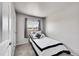 Comfortable bedroom featuring soft gray carpet, natural light, and ample space at 7831 Hollywood St, Commerce City, CO 80022