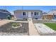 Charming single-story home with a neatly landscaped front yard and inviting entrance at 7831 Hollywood St, Commerce City, CO 80022