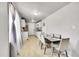 Bright kitchen with white cabinetry, stainless steel appliances, and an adjacent dining area at 7831 Hollywood St, Commerce City, CO 80022