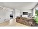 Cozy living room featuring hardwood floors, a plush sofa, and ample natural light at 7831 Hollywood St, Commerce City, CO 80022