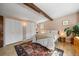 Bedroom featuring wood floors, decorative rug, wood beam, and closet at 10179 S Turkey Creek Rd, Morrison, CO 80465