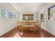 Bright dining room features wood floors, a wooden table with chairs and a bench, plus views of the outdoors at 10179 S Turkey Creek Rd, Morrison, CO 80465