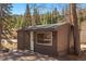 Exterior shot of a small structure features a door and window at 10179 S Turkey Creek Rd, Morrison, CO 80465