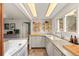Bright kitchen features white cabinets, shelving, and a window overlooking the yard at 10179 S Turkey Creek Rd, Morrison, CO 80465