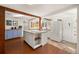 Well-lit kitchen with island, modern appliances, open shelving, and bright white walls at 10179 S Turkey Creek Rd, Morrison, CO 80465