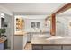 Bright kitchen features wooden beams, white appliances, and an open design at 10179 S Turkey Creek Rd, Morrison, CO 80465