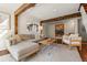 Comfortable living room showcases wood beams, an inviting sofa, and stylish decor elements at 10179 S Turkey Creek Rd, Morrison, CO 80465