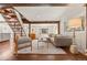 Bright living room with wood beams, stylish furniture, hardwood floors, and cozy decor at 10179 S Turkey Creek Rd, Morrison, CO 80465