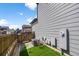 Compact backyard features artificial turf, a wooden fence, and gray exterior siding for low-maintenance outdoor living at 4581 S Kipling Cir, Denver, CO 80123