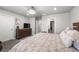 Spacious bedroom with a large dresser, neutral walls, and carpet flooring at 4581 S Kipling Cir, Denver, CO 80123
