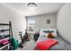Inviting bedroom featuring an exercise bike, a comfortable bed with plush pillows, and soft natural lighting at 4581 S Kipling Cir, Denver, CO 80123