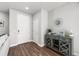 Bright entryway features wood floors, a storage cabinet, and white trim at 4581 S Kipling Cir, Denver, CO 80123