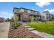 Charming two-story home with a blend of stone and siding, complemented by a well-manicured lawn at 4581 S Kipling Cir, Denver, CO 80123