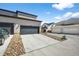Three-car garages with a wide driveway and xeriscaping at 4581 S Kipling Cir, Denver, CO 80123
