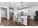 Modern kitchen features a quartz island, stainless steel appliances, and stylish pendant lighting at 4581 S Kipling Cir, Denver, CO 80123