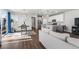 An open concept living area with kitchen, dining, and living room with hard wood floors at 4581 S Kipling Cir, Denver, CO 80123